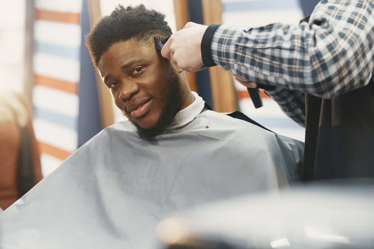Barber finishing a client's haircut